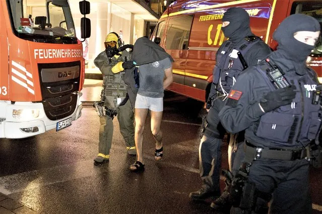 A man is taken into custody by a Special Operations Command in Castrop-Rauxel, Sunday, January 8, 2023. In Castrop-Rauxel, there was a large-scale operation by the police and fire department on Saturday evening. A special task force (SEK) was also on the scene, a police spokeswoman told the German Press Agency on Saturday evening. (Photo by Karsten Wickern/dpa via AP Photo)