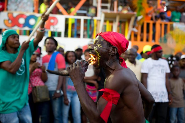 A fire eater performs during Carnival in Les Cayes, Haiti, Tuesday, February 28, 2017. (Photo by Dieu Nalio Chery/AP Photo)