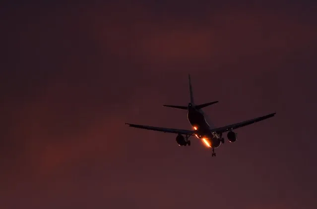 A passenger aircraft makes its landing approach at dusk at Heathrow airport in west London, Britain, March 7, 2016. (Photo by Toby Melville/Reuters)