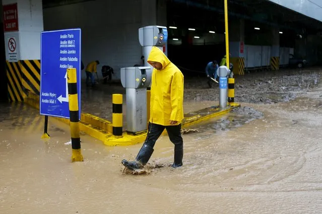 A man walks out from a flooded commercial center access in Santiago, April 17, 2016. (Photo by Ivan Alvarado/Reuters)