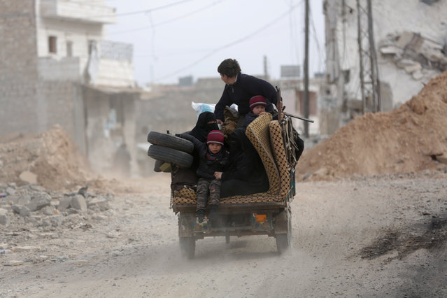 A Syrian family drives a vehicle in the northern Syrian town of al-Bab, Syria February 28, 2017. (Photo by Khalil Ashawi/Reuters)
