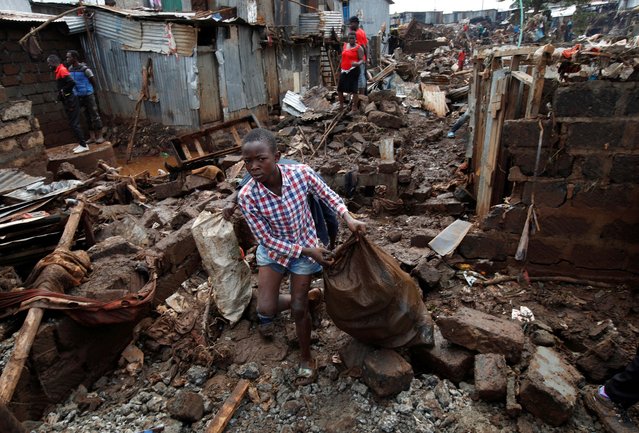 Residents sift through the rubble as they recover their belongings after the Nairobi river burst its banks and destroyed their homes within the Mathare Valley settlement in Nairobi, Kenya on April 25, 2024. (Photo by Monicah Mwangi/Reuters)