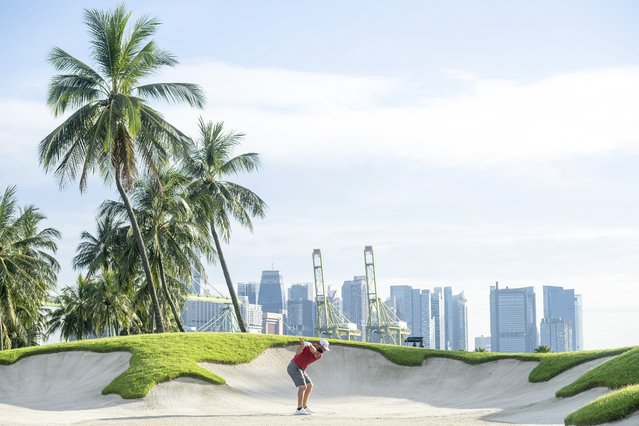 Captain Jon Rahm, of Legion XIII GC, hits his shot from the fifth bunker during the final round of LIV Golf Singapore at Sentosa Golf Club on Sunday, May 5, 2024 in Sentosa, Singapore. (Photo by Charles Laberge/LIV Golf via AP Photo)