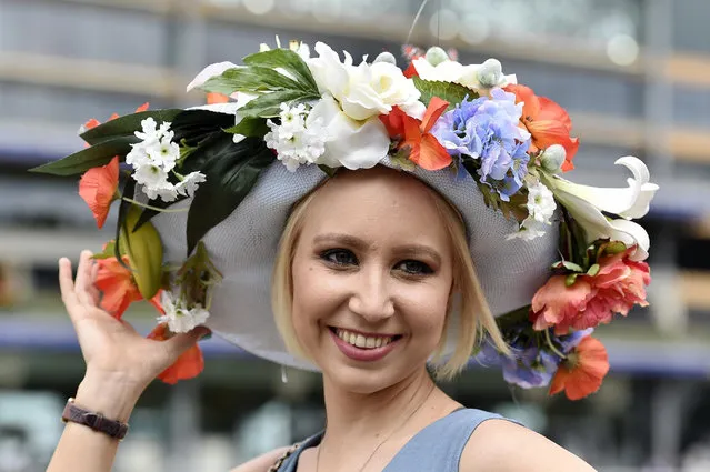 Horse Racing - Royal Ascot - Ascot Racecourse - 17/6/15
Racegoer poses with her hat as she attends the second day of racing 
Reuters / Toby Melville
Livepic
