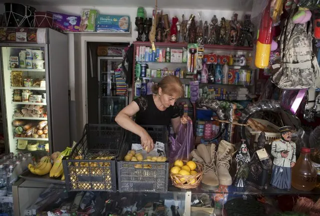 An employee works at a shop in Leningori (or Akhalgori), in the breakaway region of South Ossetia, Georgia, July 6, 2015. (Photo by Kazbek Basaev/Reuters)