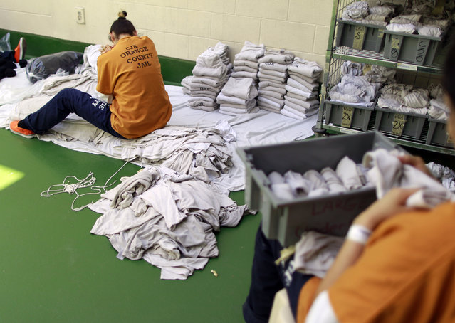 Inmates sort laundry at the Orange County jail in Santa Ana, California, May 24, 2011. (Photo by Lucy Nicholson/Reuters)