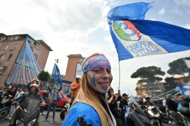 A Napoli fan looks on as Napoli supporters wave team flags outside the Diego-Maradona stadium in Naples on April 30, 2023 prior to the Italian Serie A football match between Napoli and Salernitana. Naples braces for its potential first Scudetto championship win in 33 years. With a 17 point lead at the top of Serie A, southern Italy's biggest club is anticipating its victory in the Scudetto for the first time since 1990. (Photo by Filippo Monteforte/AFP Photo)