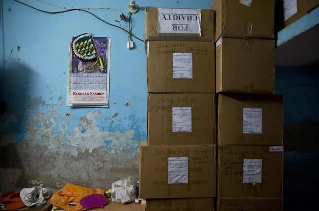 In this June 8, 2015 photo, a part of the tiny living space of Omkarnath, who has also rented a separate small room to store medicines, is occupied by boxes of medicines at a fetid slum in New Delhi, India. (Photo by Saurabh Das/AP Photo)