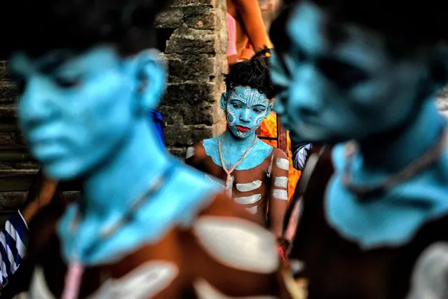 A Hindu devotee with his face painted as part of their traditional practices participates during the annual Gajan Festival in Bardhaman, India on April 12, 2022. Gajan is a Hindu festival celebrated mostly in the rural part of West Bengal. Gajan spans around a week, starting mid-April. Participants of this festival are known as Sannyasi or Devotees. The central theme of this festival is deriving satisfaction through non-sexual pain, devotion, and sacrifice. (Photo by Avishek Das/SOPA Images/LightRocket via Getty Images)