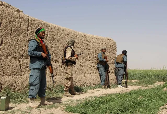 Afghan policemen keep watch during a battle with the Taliban in Nahr-e Saraj district of Helmand province, Afghanistan May 11, 2016. (Photo by Abdul Malik/Reuters)