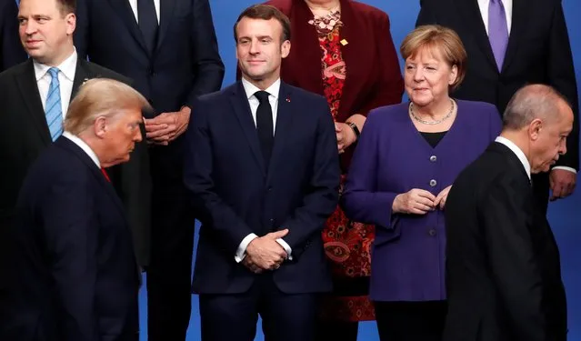 France's President Emmanuel Macron and Germany's Chancellor Angela Merkel look on as U.S. President Donald Trump and Turkey's President Recep Tayyip Erdogan walk during a photo opportunity at the NATO leaders summit, December 4, 2019. (Photo by Christian Hartmann/Pool via Reuters)