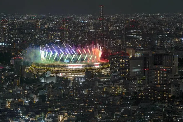 Fireworks illuminate over National Stadium viewed from Shibuya Sky observation deck during the closing ceremony for the 2020 Paralympics in Tokyo, Sunday, September 5, 2021. (Photo by Kiichiro Sato/AP Photo)