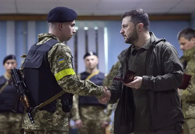 In this photo provided by the Ukrainian Presidential Press Office on Sunday, May 29, 2022, Ukrainian President Volodymyr Zelenskyy, right, awards a servicewoman as he visits the war-hit Kharkiv region. Volodymyr Zelenskyy described the situation in the east as  “indescribably difficult”. The “Russian army is trying to squeeze at least some result” by concentrating its attacks there, he said in a Saturday night video address. Photo by Ukrainian Presidential Press Office via AP Photo)