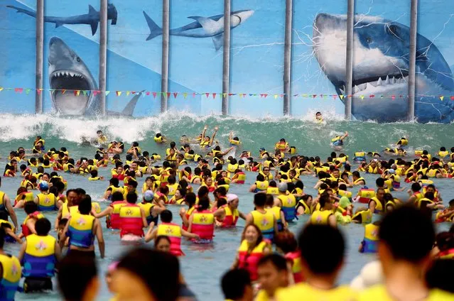 Huge crowds of people play at THEBES Happiness Water World during a continuous high temperature on July 5, 2014 in Shaanxi, Xi'an province of China. (Photo by ChinaFotoPress/ChinaFotoPress via Getty Images)