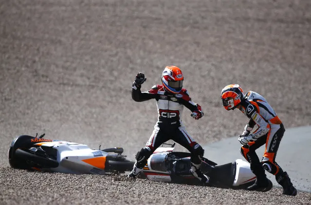 Mahindra Moto3 rider Bryan Schouten of the Netherlands fights with compatriot Kalex KTM Moto3 rider Scott Deroue (R) after they crashed during the German Grand Prix at the Sachsenring circuit in the eastern German town of Hohenstein-Ernstthal July 13, 2014. (Photo by Thomas Peter/Reuters)