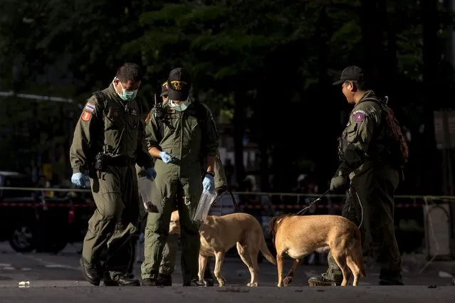 Experts investigate near the site of a deadly blast in central Bangkok, Thailand, August 18, 2015. (Photo by Athit Perawongmetha/Reuters)