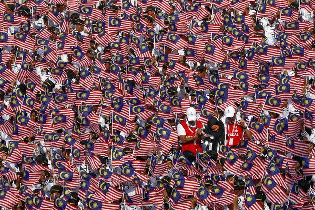 Medical officials assist a student that fainted during Independence Day celebrations in Putrajaya, Malaysia, 31 August 2019. Malaysia gained its independence from British colonial rule in 1957. (Photo by Ahmad Yusni/EPA/EFE)