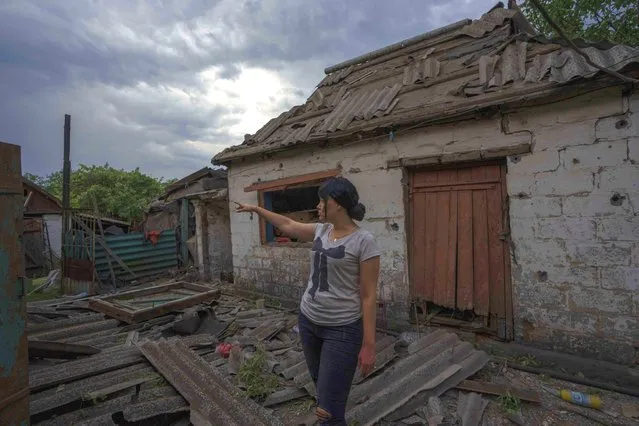 A resident stands in front of a damaged home, in the aftermath of a Russian rocket attack, on the outskirts of Pokrovsk, eastern Ukraine, Saturday, July 16, 2022. (Photo by Nariman El-Mofty/AP Photo)