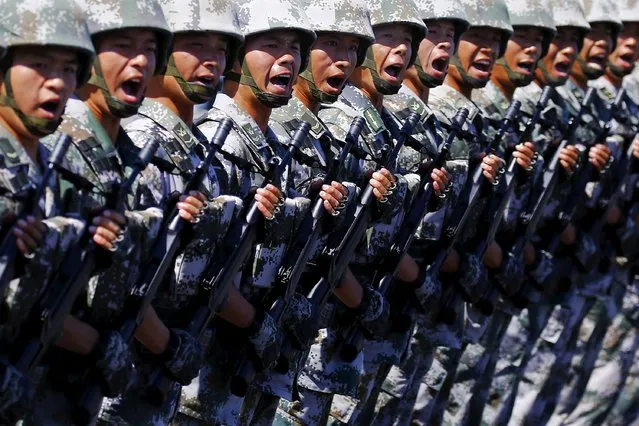 Soldiers of China's People's Liberation Army shout as they march with their weapons during a training session for a military parade to mark the 70th anniversary of the end of World War Two, at a military base in Beijing, China, August 22, 2015. (Photo by Damir Sagolj/Reuters)