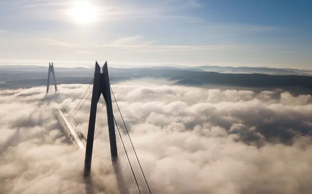 An aerial picture taken by drone shows Yavuz Sultan Selim Bridge under heavy fog at the Bosphorus in Istanbul, Turkey 10 January​ 2020. Due to heavy fog Bosphorus closed to transit ships on 10 January. (Photo by Tolga Bozoglu/EPA/EFE)