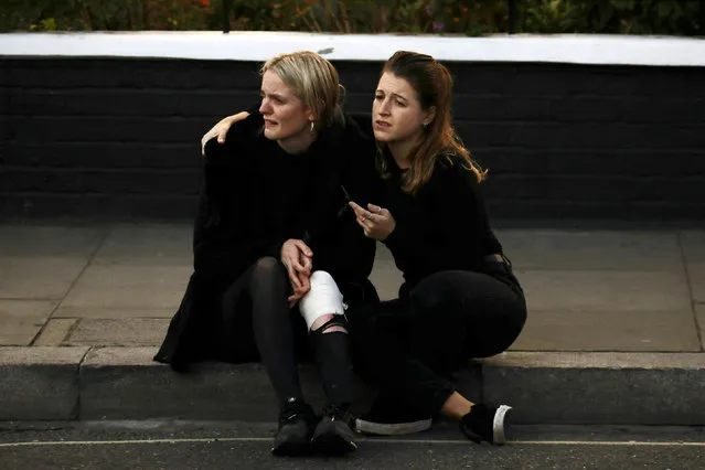 An injured woman reacts outside Parsons Green tube station in London, Britain September 15, 2017. (Photo by Kevin Coombs/Reuters)