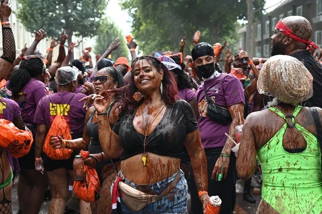 Revellers enjoy the Notting Hill Carnival for the first time in three years in London, United Kingdom on August 28, 2022. (Photo by Simon Jones/The Sun)