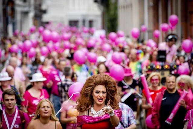 People wear costumes as they attend “Pink Monday”, the biggest funfair in Tilburg, Netherlands, July 25, 2016. “Pink Monday” is a special day for the LGBT (lesbian, gay, bisexual, and transgender) community and runs from July 22nd until 31st. (Photo by Robin Van Lonkhuijsen/EPA)
