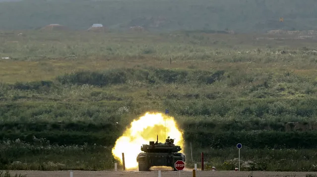 A tank fires at a target on the course of the Tank Biathlon competition during the International Army Games 2016 in Alabino, outside Moscow, Russia, July 30, 2016. (Photo by Maxim Zmeyev/Reuters)