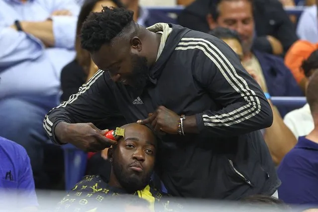 A fan gets his haircut during their Men’s Singles Quarterfinal match between Nick Kyrgios of Australia and Karen Khachanov on Day Nine of the 2022 US Open at USTA Billie Jean King National Tennis Center on September 06, 2022 in the Flushing neighborhood of the Queens borough of New York City. (Photo by Elsa/Getty Images)