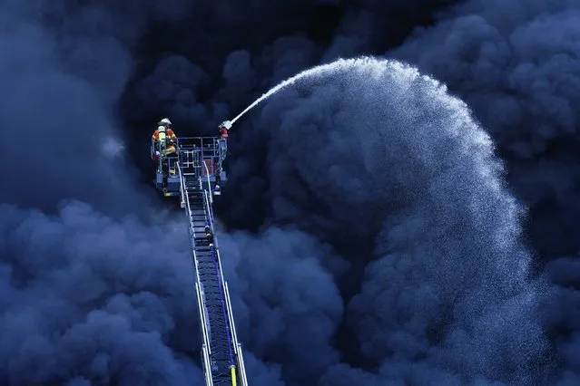 Firefighters are fighting a fire at a plastics factory in front of a huge cloud of smoke in Ladenburg, Germany, Tuesday, May 19, 2020. (Photo by Uwe Anspach/dpa via AP Photo)