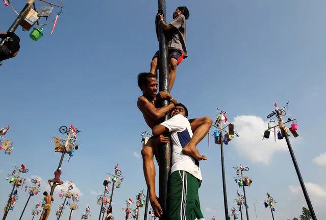 Participants climb greased poles to collect prizes during a “Panjat Pinang” event organised in celebration of Indonesia's 71st Independence day in Jakarta, Indonesia August 17, 2016. (Photo by Iqro Rinaldi/Reuters)