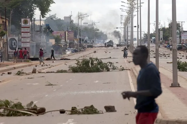 Members of the presidential guard dismantle roadblocks set up by anti-coup protesters in Ouagadougou, Burkina Faso, September 18, 2015. (Photo by Joe Penney/Reuters)