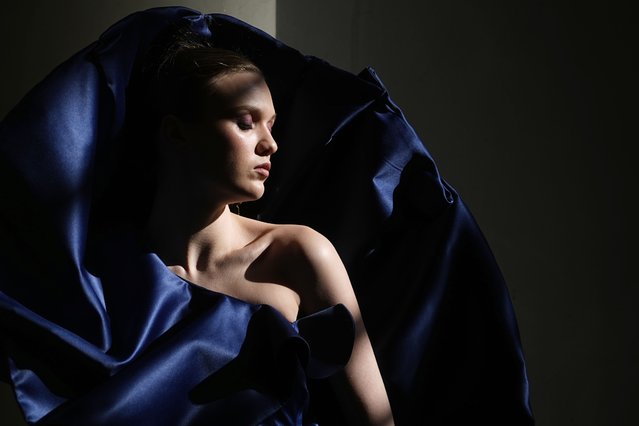 Sunlight illuminates a model backstage at Moscow Fashion Week in Moscow, Russia, Tuesday, March 18, 2025. (Photo by Pavel Bednyakov/AP Photo)