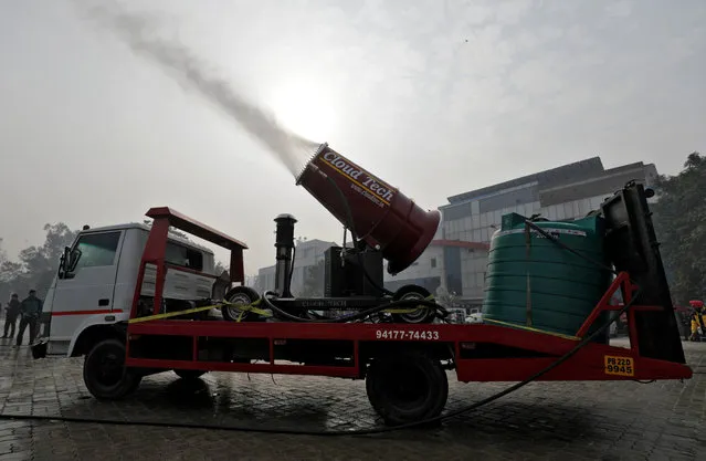 An “anti-smog gun”, a machine that sprays atomised water into the air to reduce pollution, is pictured during its trial run organised by the Department of Environment and Delhi Pollution Control Committee at a bus terminal in New Delhi, India, December 20, 2017. (Photo by Saumya Khandelwal/Reuters)