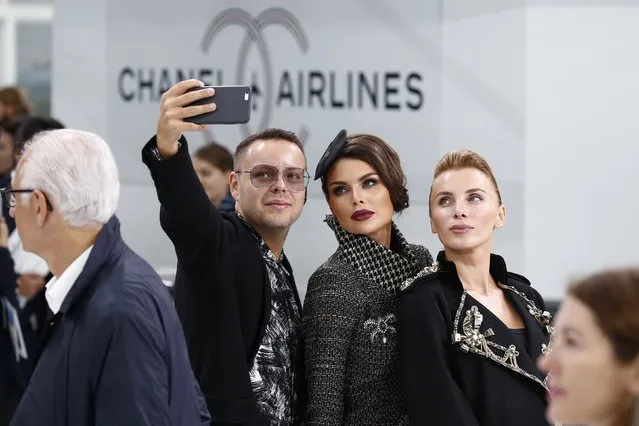 Unidentified guests take selfies at the Grand Palais which is transformed into a Chanel airport before German designer Karl Lagerfeld's Spring/Summer 2016 women's ready-to-wear collection for French fashion house Chanel during the Fashion Week in Paris, France, October 6, 2015. (Photo by Benoit Tessier/Reuters)