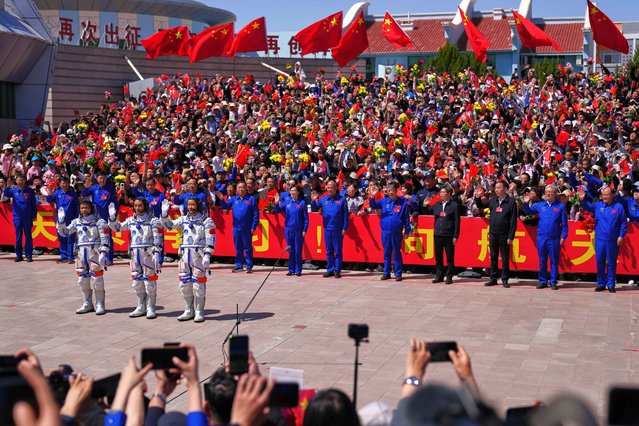 Chinese astronauts for the Shenzhou 20 mission, from right, Chen Zhongrui, Chen Dong and Wang Jie wave as they attend a send-off ceremony for their manned space mission at the Jiuquan Satellite Launch Center in northwestern China, Thursday, April 24, 2025. (Photo by Andy Wong/AP Photo)