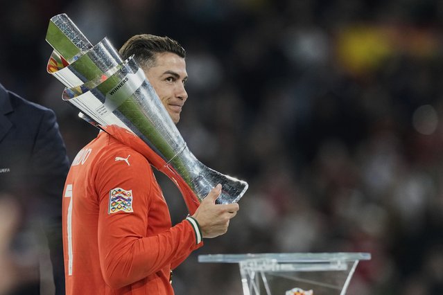 Portugal's Cristiano Ronaldo holds the trophy after winning the Nations League final soccer match between Portugal and Spain at the Allianz Arena in Munich, Germany, Monday, June 9, 2025. (Photo by Martin Meissner/AP Photo)