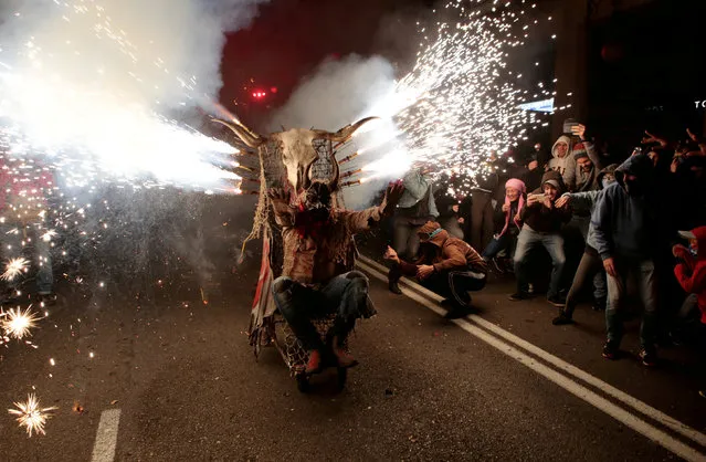 A reveller dressed as a devil rides among fireworks during “Correfocs” (fire runs), traditional celebrations in eastern Spain with people dressed as dancing devils while lighting fireworks among crowds of spectators, to mark the end of the local festivities in Palma de Mallorca, Spain, January 21, 2018. (Photo by Enrique Calvo/Reuters)