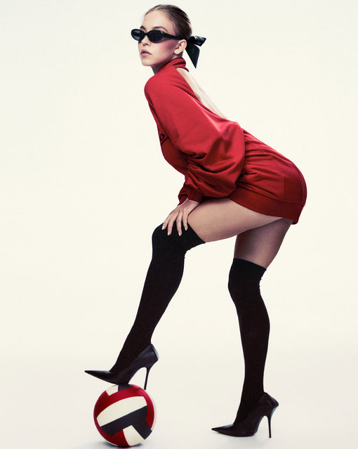 In another photo Sydney is posed in a red Balenciaga dress with a football and high heels. (Photo by Carlijn Jacobs)