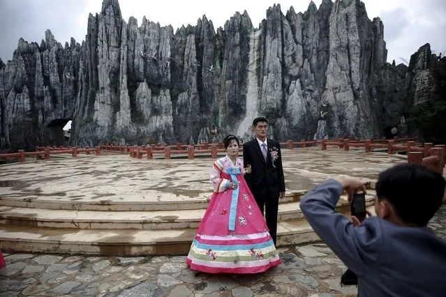 O Yang Ran and her husband Kim Chol Nam pose during a photo session at Pyongyang Folk Park, October 11, 2015. (Photo by Damir Sagolj/Reuters)