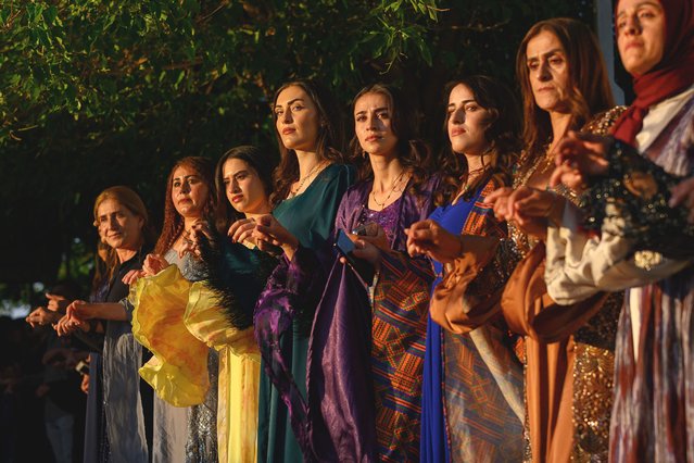 Guests take part in the “Halay” -a traditional form of dance- during a Kurdish wedding in the southeast province of Hakkari, on July 12, 2025. Colourful dresses, stacks of cash and hours of dancing, Kurdish weddings in Turkey are a unique spectacle which gather hundreds, sometimes thousands of guests at a time. More secluded in the past to avoid public attention due to the bloody conflict between the outlawed Kurdistan Workers' Party (PKK) and the Turkish state, these weddings?have now stepped out of the shadows. (Photo by Yasin Akgul/AFP Photo)