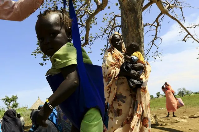 A child is weighed during visit by a European Union delegation, at an IDP camp in Azaza, east of Ed Damazine, capital of Blue Nile state, October 21, 2015. (Photo by Mohamed Nureldin Abdallah/Reuters)