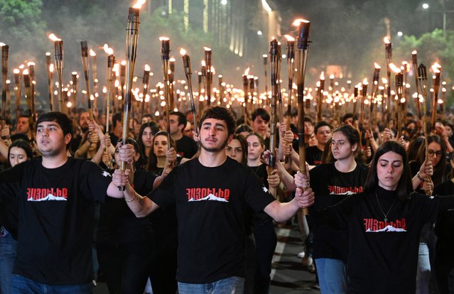 Armenians take part in the annual torch march on the eve of the Genocide Remembrance Day in Yerevan, on April 23, 2024, to mark the 109th anniversary of the World War I-era mass killings of Armenians under the Ottoman Empire in 1915. (Photo by Karen Minasyan/AFP Photo)