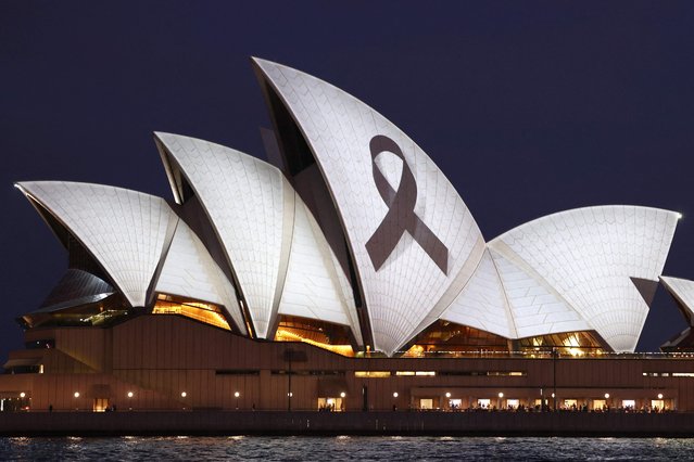 A black ribbon is projected onto the Sydney Opera House on April 15, 2024, as a mark of respect for the victims of the Westfield Bondi Junction shopping mall attack. A 40-year-old knifeman with mental illness roamed the packed shopping centre on April 13, killing six people and seriously wounding a dozen others. (Photo by David Gray/AFP Photo)