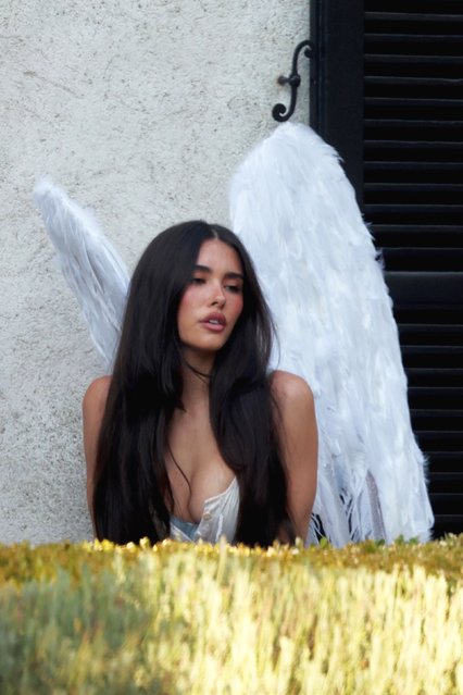 Madison Beer rocks angel wings as she poses for a photo shoot in Los Angeles on August 17, 2025. The singer was spotted at a house in Hancock Park for the shoot which ran all day. Wearing what appeared to be a nightshirt, Madison was seen posing with a heart locket and a tiny heart ring. Afterwards she was seen introducing a man to various crew members. The mystery man only showed up at around 4:30 and Madison left the set in his car. Her second outfit was a corset and angel wings. Madison wore her corset partially unbuttoned as she posed for the portraits. (Photo by Backgrid USA)