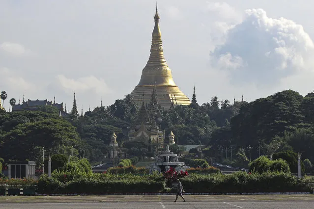 A man takes his morning walk near the Shwedagon pagoda in Yangon, Myanmar, on Thursday, November 5, 2020. (Photo by Thein Zaw/AP Photo)