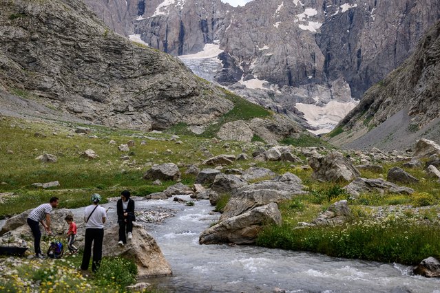 People rest on the Cilo Glaciers of Turkey's southeastern Hakkari province, on July 13, 2025. (Photo by Yasin Akgul/AFP Photo)