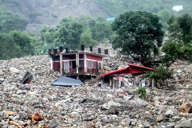 A residential building is pounded by rocks after a cloudburst following heavy rains in the Sahastradhara region of Dehradun, in India's Uttarakhand state on September 16, 2025. (Photo by AFP Photo/Stringer)