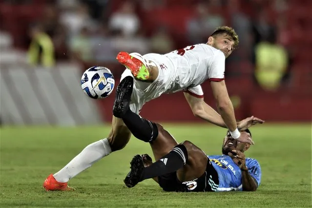 Gaston Sauro of Argentina's Huracan, top, fights for the ball with Bremer of Peru's Sporting Cristal during a Copa Libertadores soccer match at Tomas Duco stadium in Buenos Aires, Argentina, Thursday, March 9, 2023. (Photo by Gustavo Garello/AP Photo)