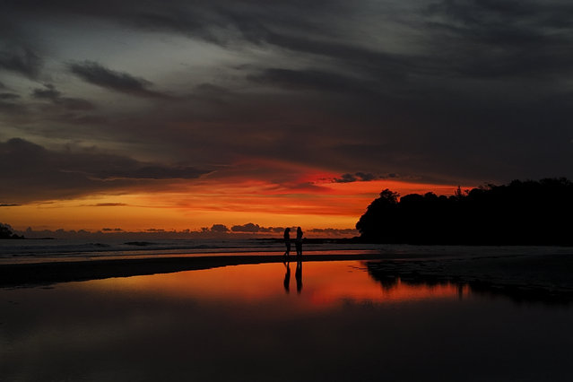 People walk along the shore in Santa Catalina, Panama, Wednesday, August 6, 2025. (Photo by Matias Delacroix/AP Photo)